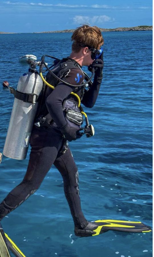 Student diver taking a giant stride entry off the boat