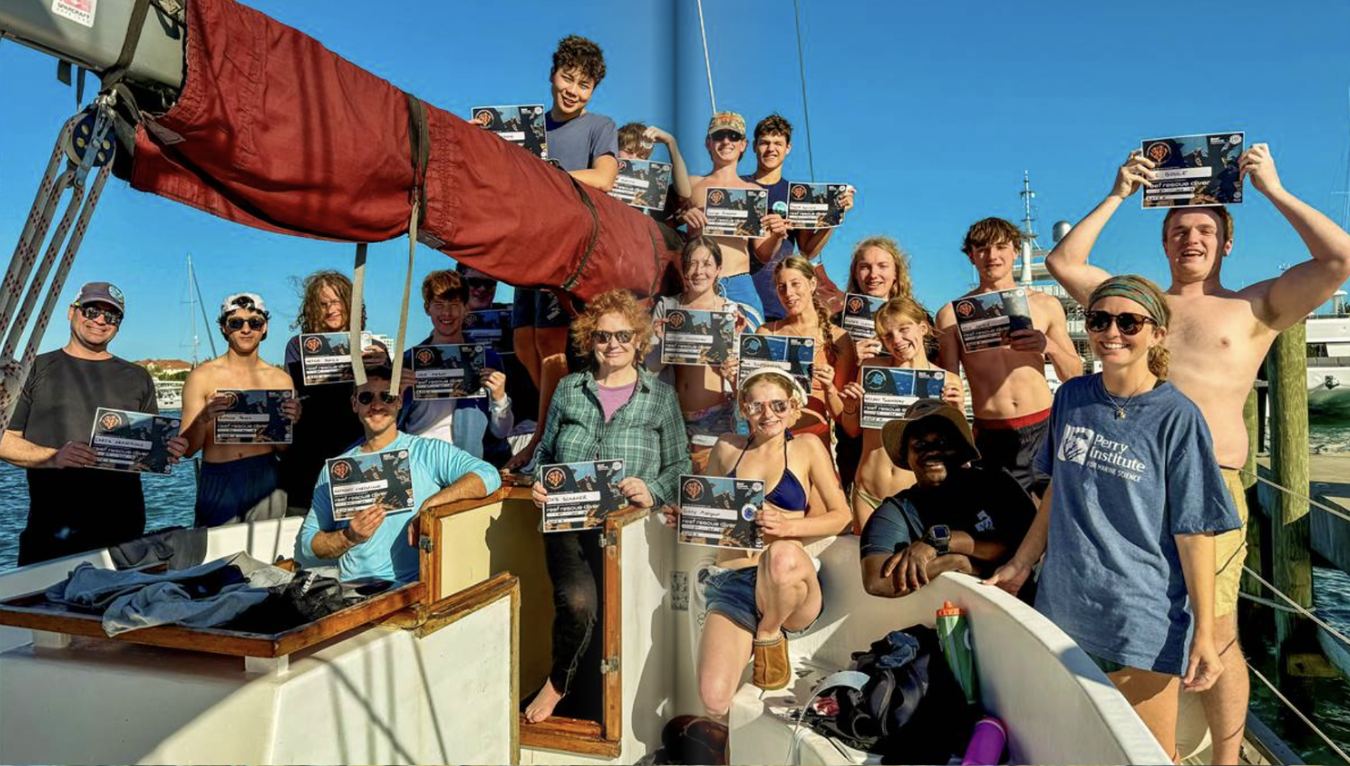 RUHS dive team and Perry Institute scientists on the deck of the Morning Star holding their reef rescue diver certificates